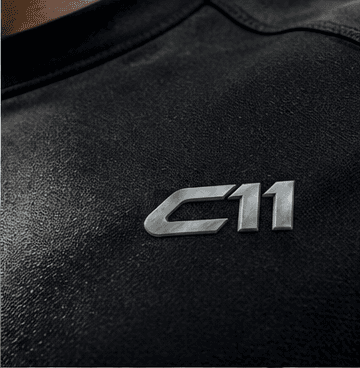 Metal C11 badge on black knit fabric